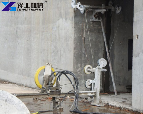 concrete rope saw cutting thick concrete wall on construction site