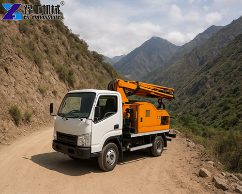 small concrete pump truck working on mountain road construction site in peru