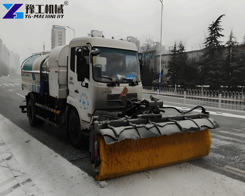 snow sweeper roller clearing snow on road