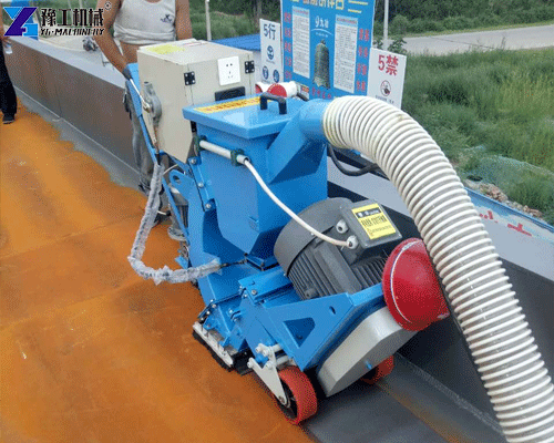 Floor shot blaster removing old coatings from pavement