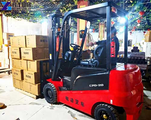 Compact electric forklift maneuvering through a narrow warehouse aisle