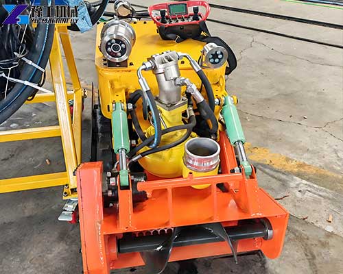 Front auger system loosening compacted sludge before suction operation