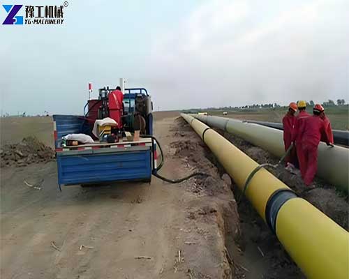 Polyurethane foam spray machine spraying insulation on industrial pipes