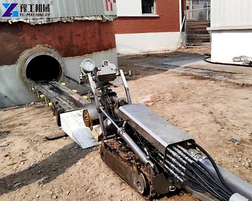 Sludge removal robot cleaning accumulated sediment from a tank