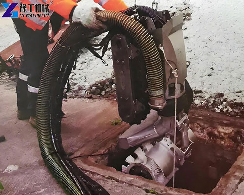 Sludge removal robot entering a restricted-access tank through a narrow opening
