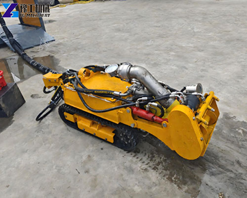 Operator remotely controlling a sludge removal robot from outside the cleaning area
