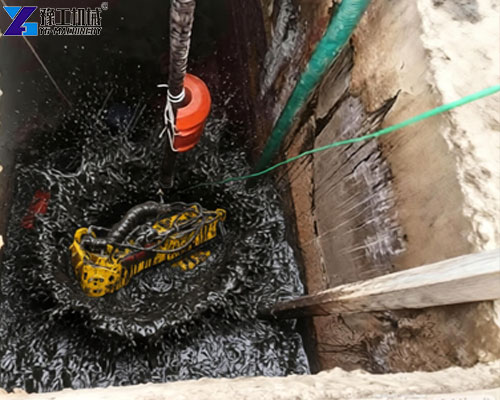 sludge removal robot operating inside a concrete tank to remove accumulated sludge