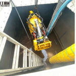 YG450 compact dredging robot being lowered through an 800 mm tank entrance